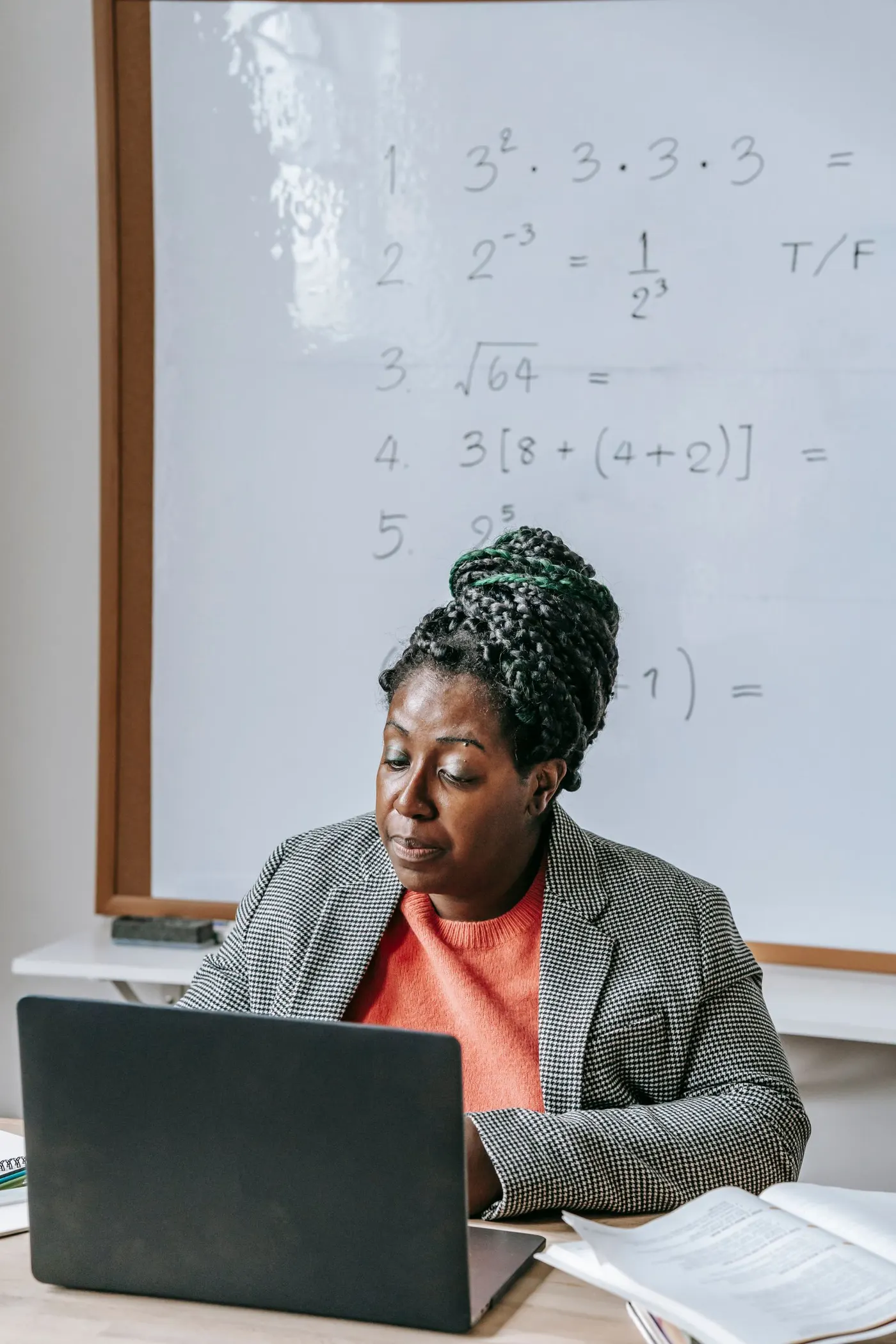An Educ8 Academy facilitator working through material on a laptop, blending online and in-person teaching